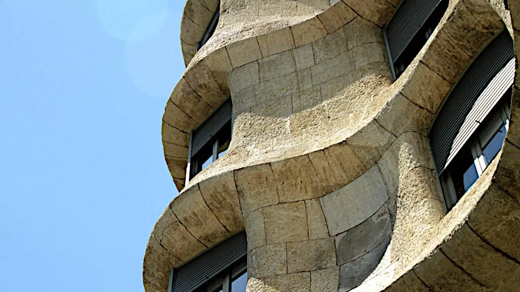 Detailed of sandy-brown stone facade of Casa Milà in Barcelona